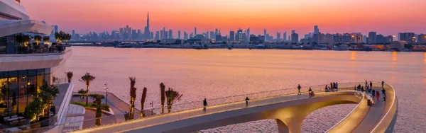 Dubai Creek Harbour promenade overlooking Dubai Creek, with Downtown Dubai across the water