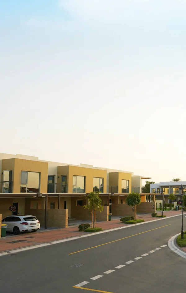 Occupied villa street in Arabian Ranches II, with cars, gardens and landscaped pavements