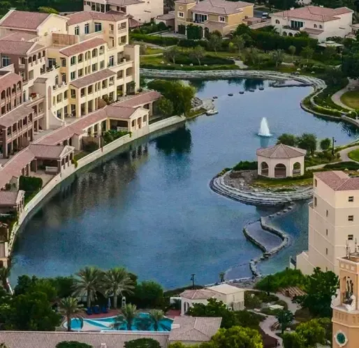 Lake and residential buildings in Green Community Motor City, within the wider Dubai Motor City destination